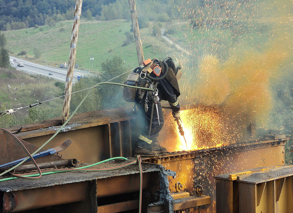 Worker welding on bridge