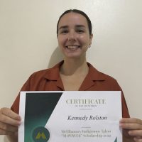 Kennedy Rolston holding her scholarship certificate