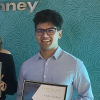 Swikar Bahyal holding his scholarship certificate