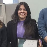 Vivian Pena holding her scholarship certificate