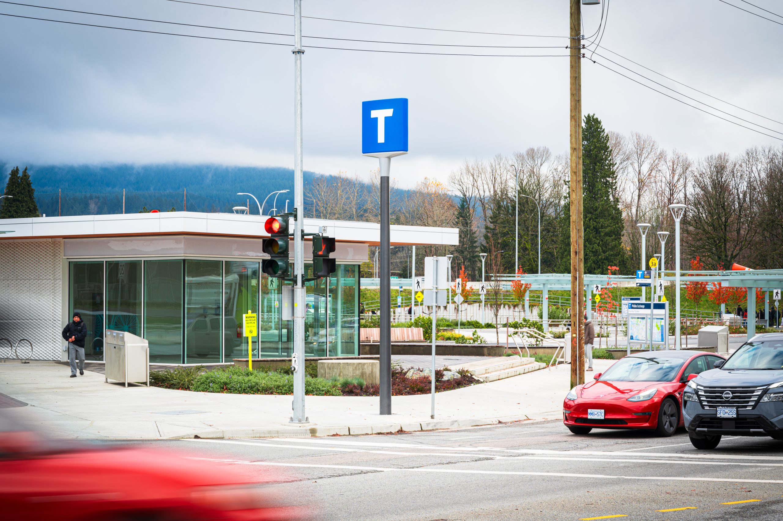 Transit building and intersection at the Phibbs Transit Exchange with shelters and pedestrian crossings.