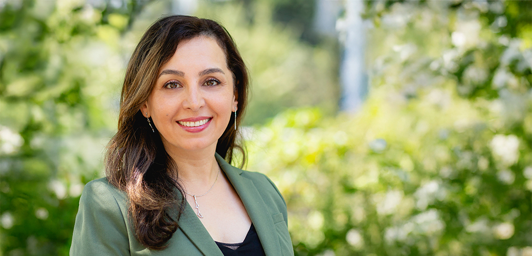 Employee headshot with treed background