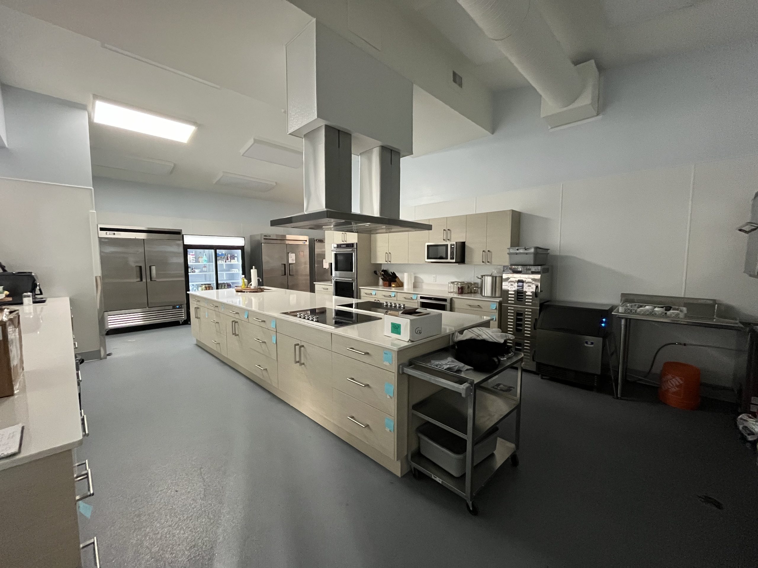 Interior photo of a brightly lit, newly installed industrial kitchen.