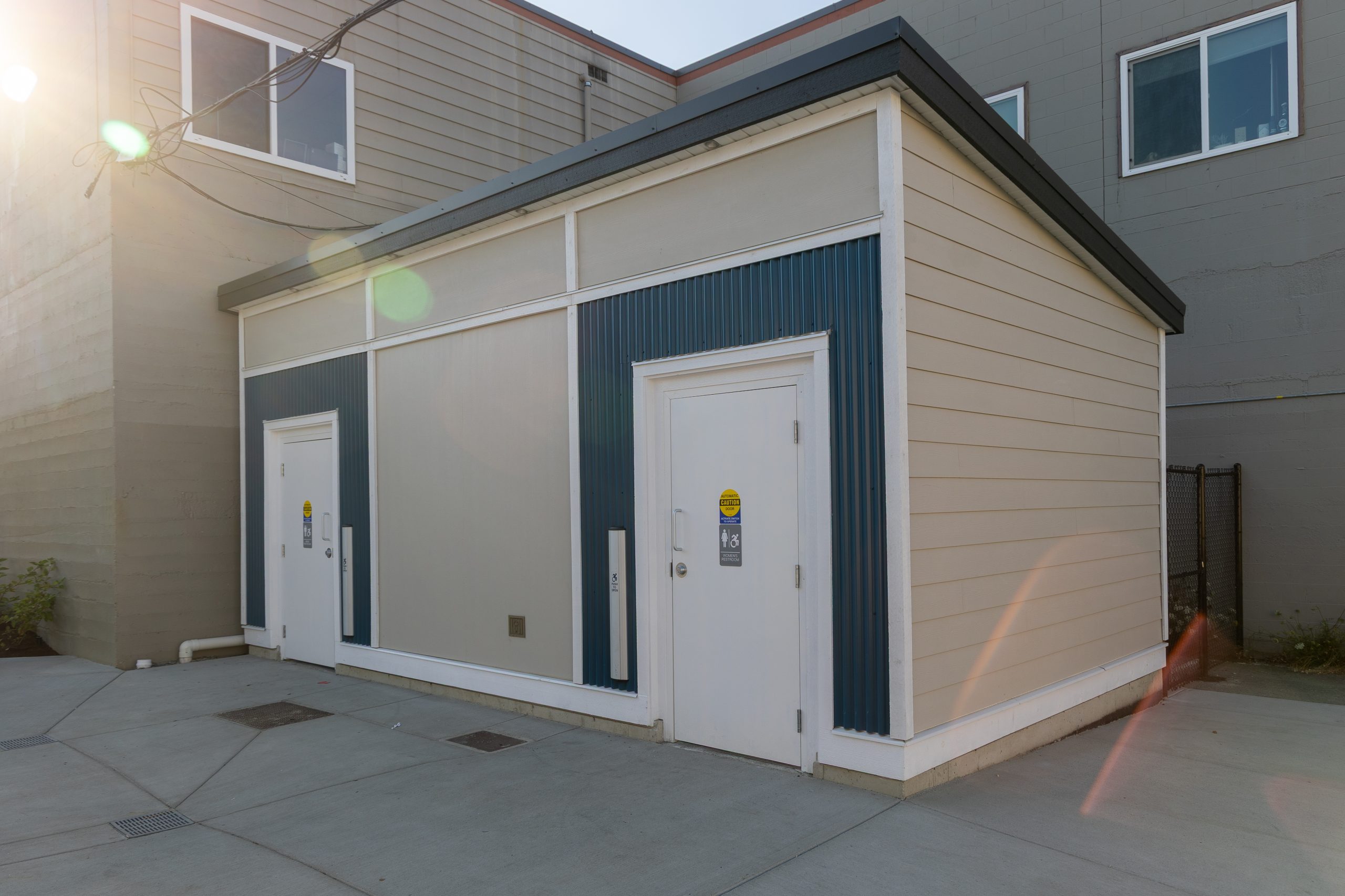 Small public restroom building with two accessible entrances.