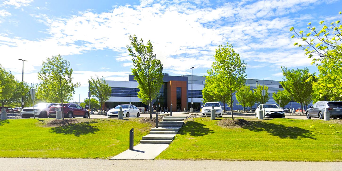 Street view of the Alberta Gaming and Liquor Distribution Centre in St. Albert, Alberta, showing the main warehouse building and surrounding area.