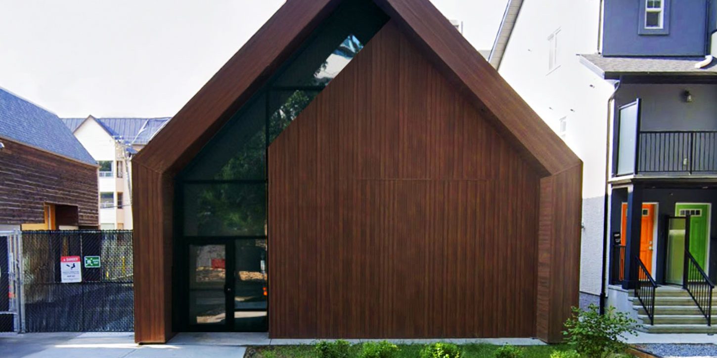 A front view of the EPCOR Garneau Substation, showcasing its modern architectural design with a wooden facade and large glass entrance.