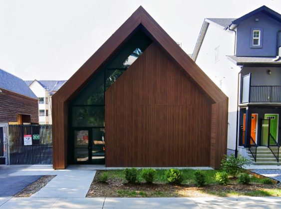 A front view of the EPCOR Garneau Substation, showcasing its modern architectural design with a wooden facade and large glass entrance.