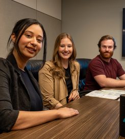 Interns and team members meeting together in a welcoming, collaborative workplace environment.