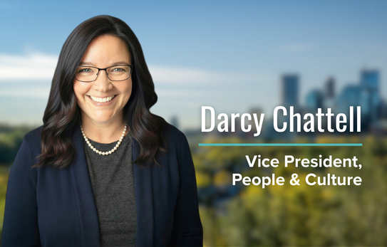Professional portrait of Darcy Chattell, Vice President, People & Culture at McElhanney, with a cityscape background.