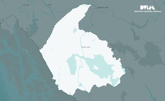 Map highlighting a white‑shaded region centered on Dease Lake in northern British Columbia, with surrounding towns labeled in grey.