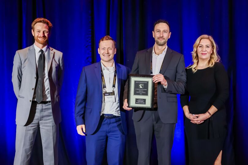 McElhanney team members accepting an industry excellence award at a professional engineering conference