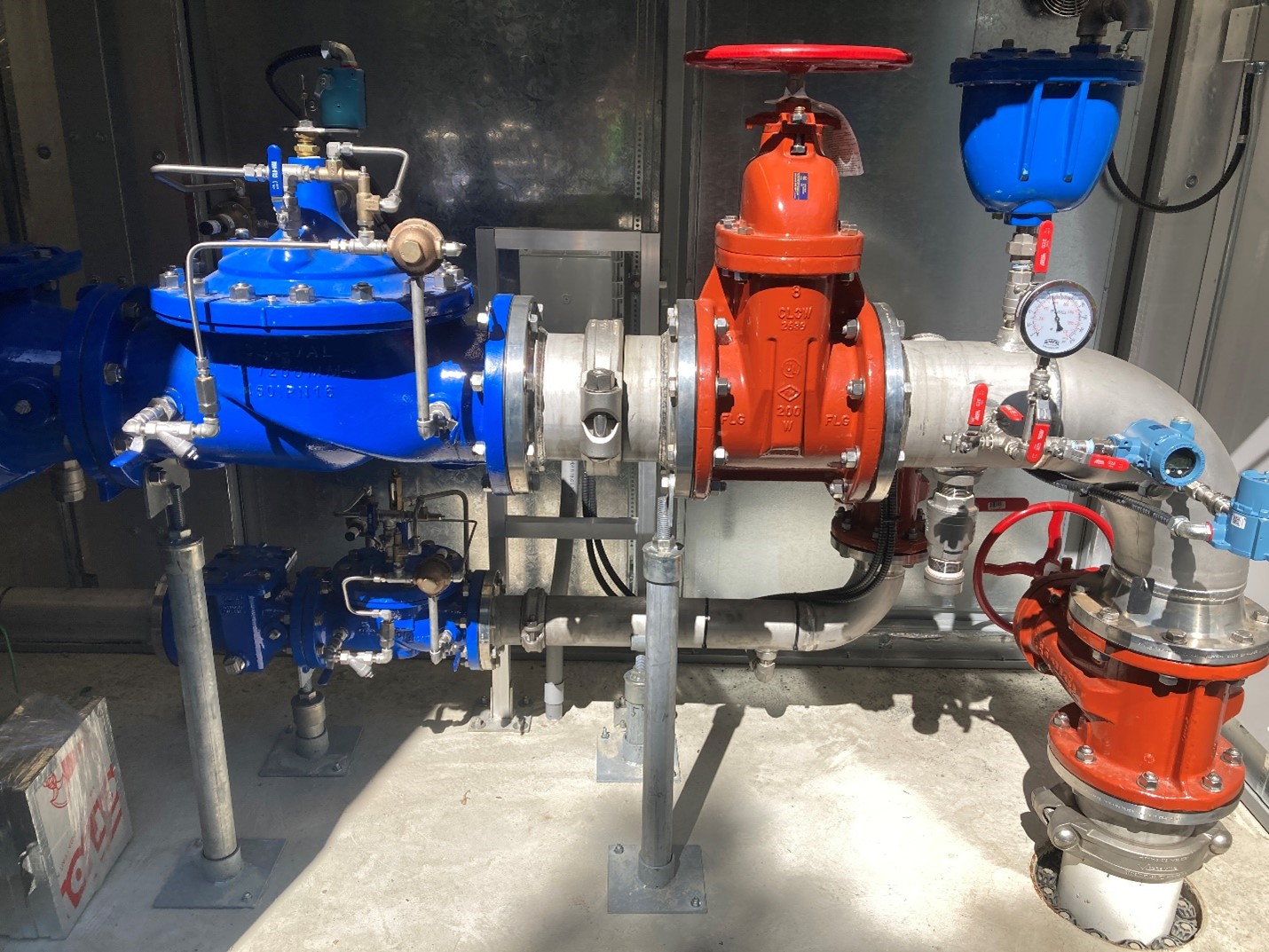 Wilkinson–Burnside PRV Station Interior with Dual Pressure Reducing Valves Interior view of the Wilkinson–Burnside PRV station showing two pressure reducing valves connected by stainless steel piping and mechanical grooved couplings.