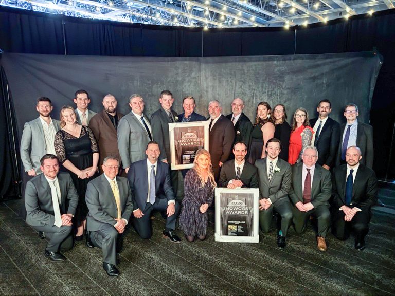 Group photo of McElhanney project team members holding 2026 CEA Showcase Awards during the awards ceremony.