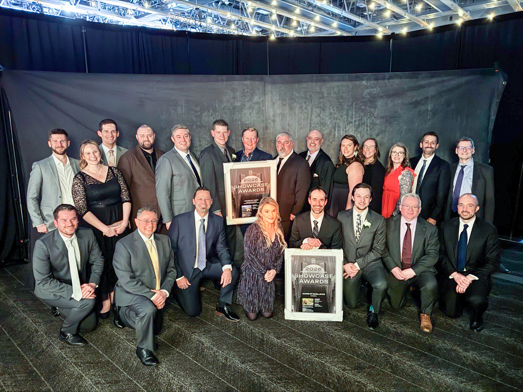Group photo of McElhanney project team members holding 2026 CEA Showcase Awards during the awards ceremony.