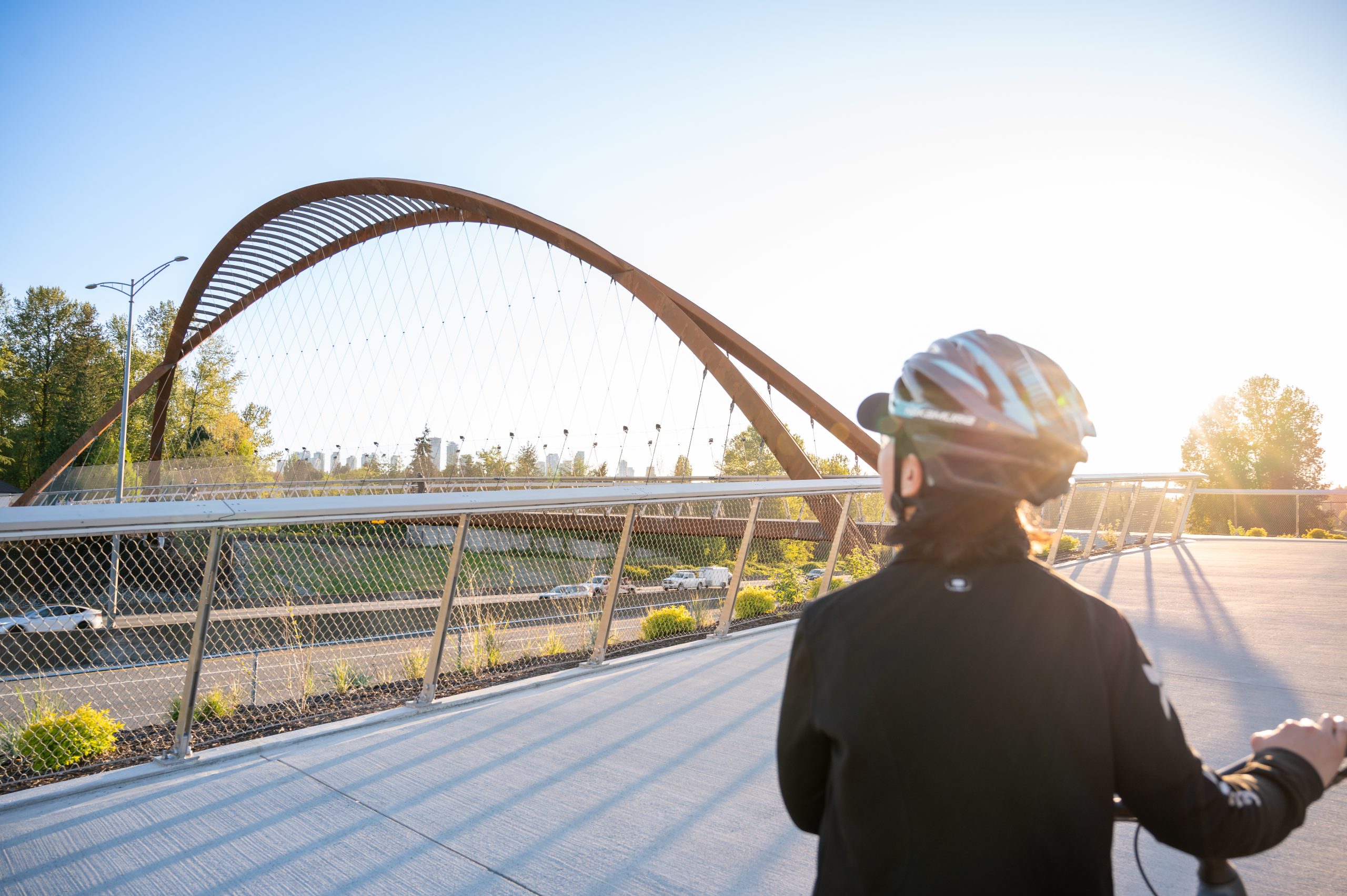 Cyclist Approaching the Burnaby Lake Pedestrian Bridge Angled view of the Burnaby Lake Pedestrian Bridge with a cyclist in Burnaby, B.C.