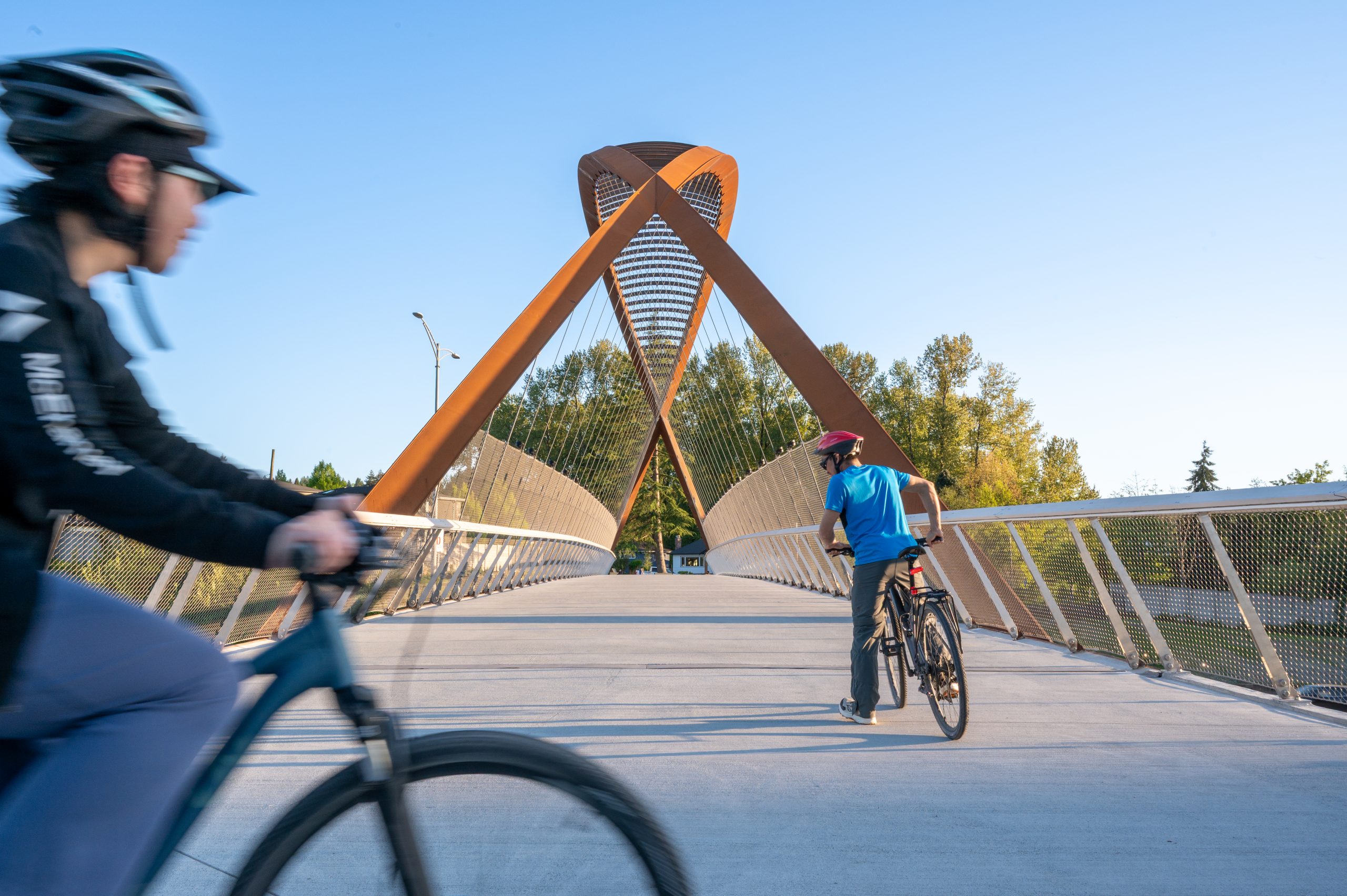 Cyclists Crossing the Burnaby Lake Pedestrian Bridge Burnaby Lake Pedestrian Bridge with two cyclists crossing in Burnaby, B.C.