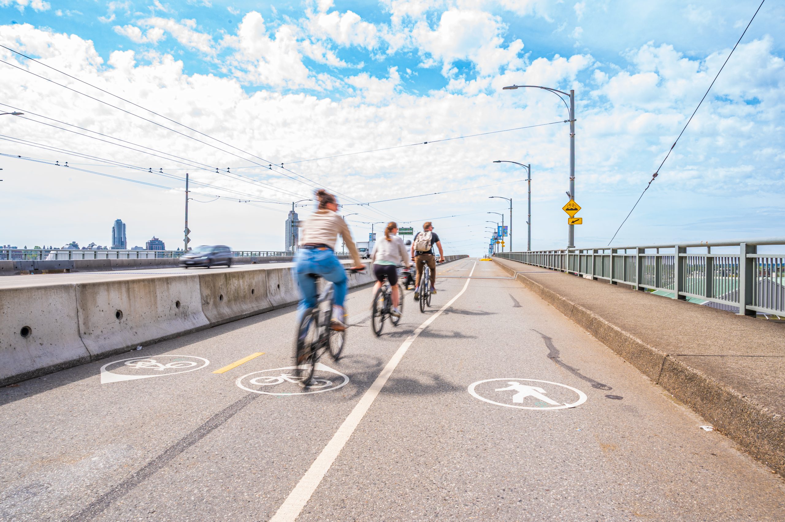 New Cycling Infrastructure Supports Safer Travel Across Granville Bridge People cycling on the Granville Bridge along bike lanes designed for safe travel.