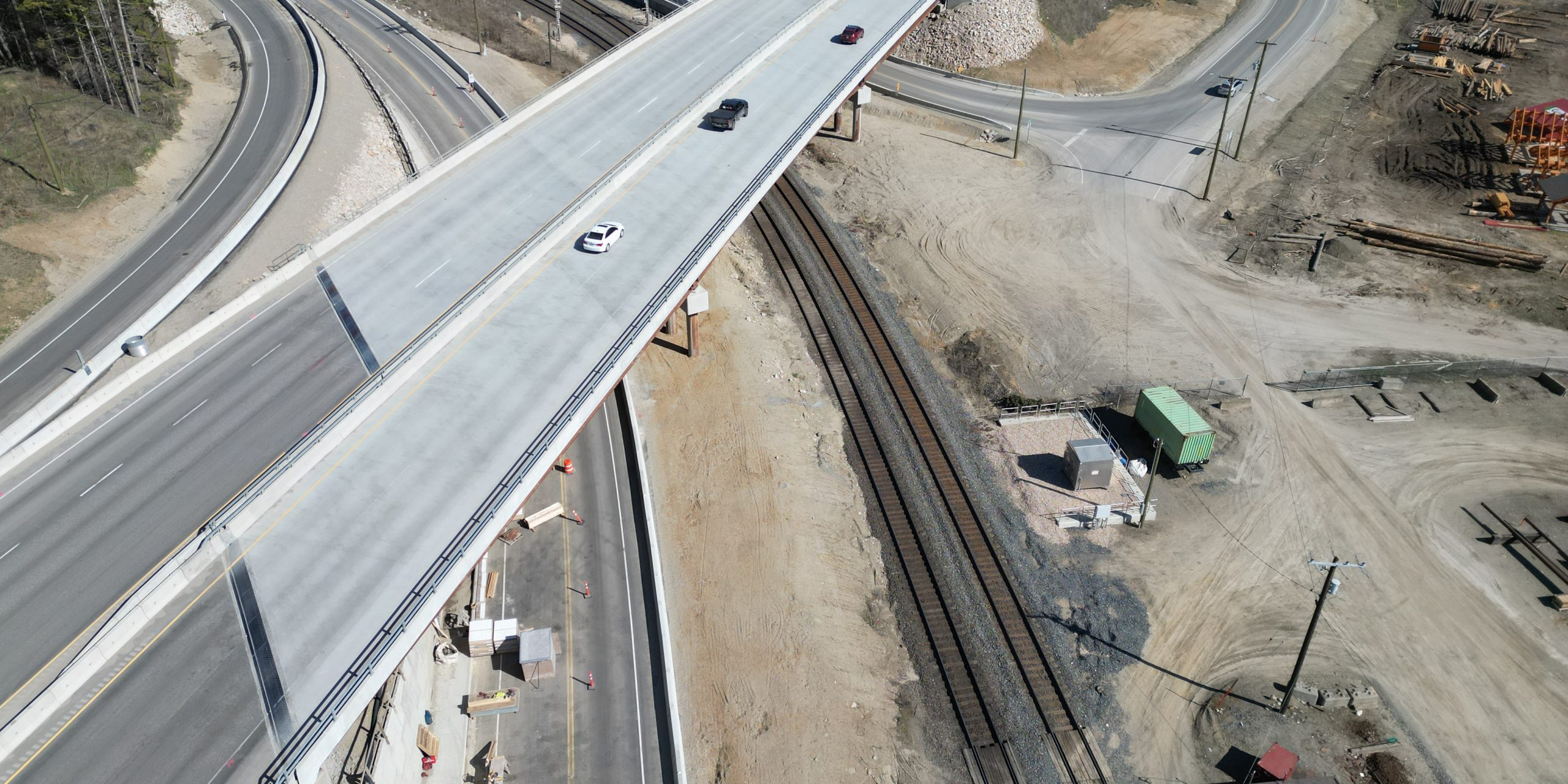Aerial view of a new Highway 1 overpass crossing local roads and railway infrastructure as part of the Ford Road to Tappen Valley Road highway upgrades in British Columbia.