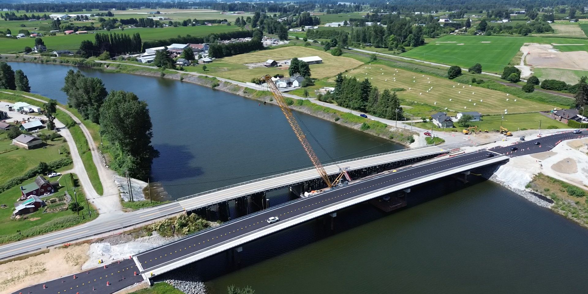 Aerial view of the new Dewdney Bridge under construction beside the existing bridge crossing Nicomen Slough in Dewdney, British Columbia.
