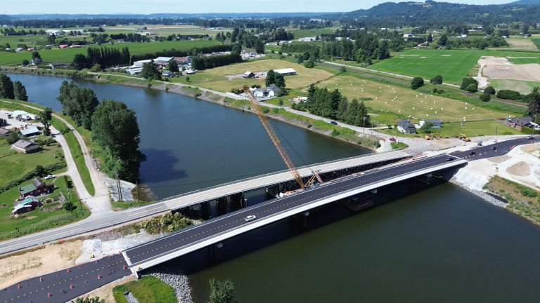 Aerial view of the new Dewdney Bridge under construction beside the existing bridge crossing Nicomen Slough in Dewdney, British Columbia.