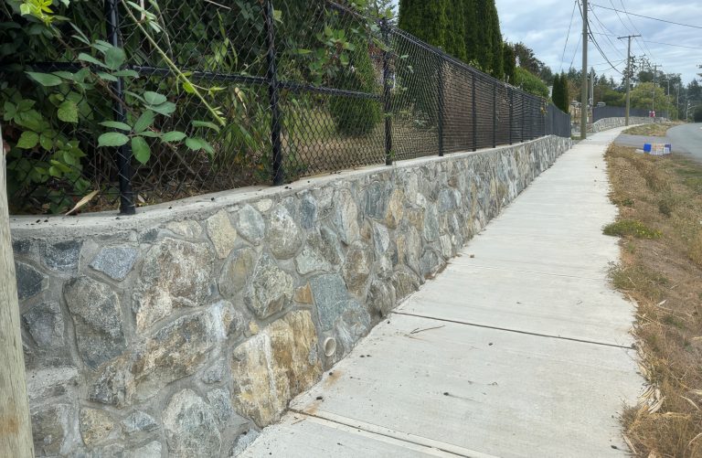Stone retaining wall alongside a public sidewalk in Victoria, British Columbia, assessed as part of a municipal infrastructure inventory and condition assessment program.