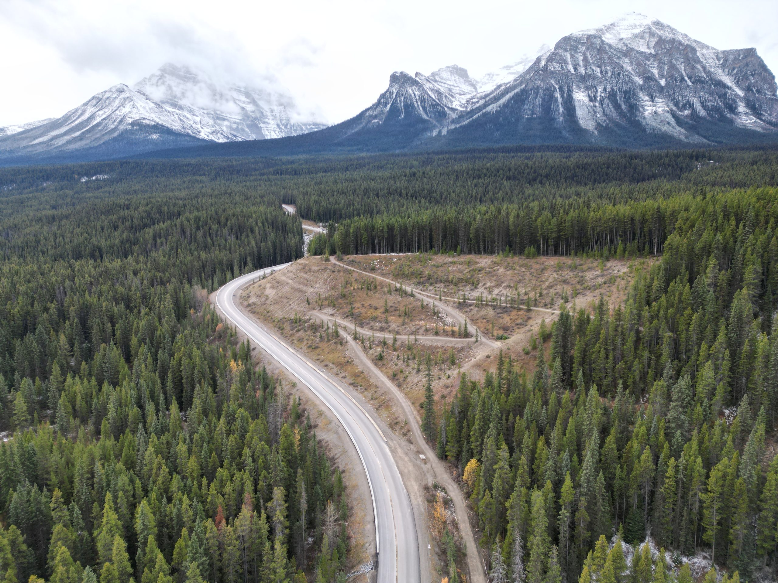 Aerial view of Lake Louise Drive Aerial view of Lake Louise Drive and realigned Tramline Trail through forested landscape in Banff National Park