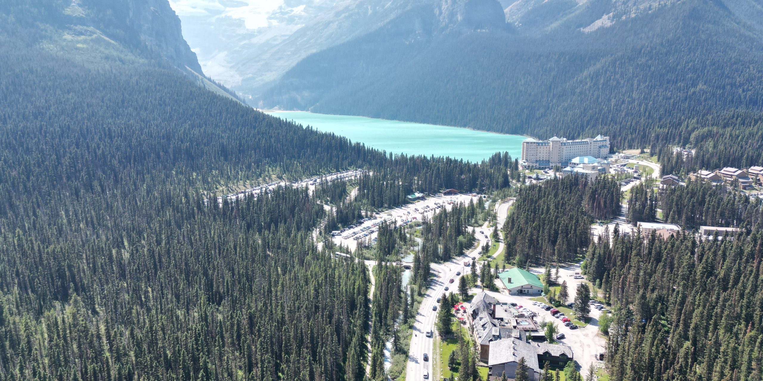 Aerial view of Lake Louise, visitor parking areas, and Fairmont Chateau Lake Louise in Banff National Park