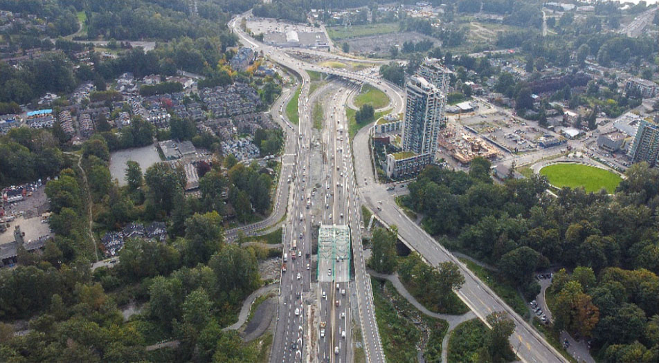 Aerial view of the Highway 1 corridor and surrounding transportation infrastructure near the Lynn Creek Bridge in North Vancouver, British Columbia.