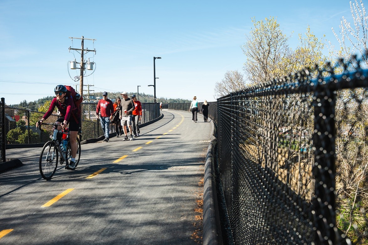Photo Credit: Jesse Holland Photography. Pedestrians and cyclists enjoying the Galloping Goose Trail Bridge.