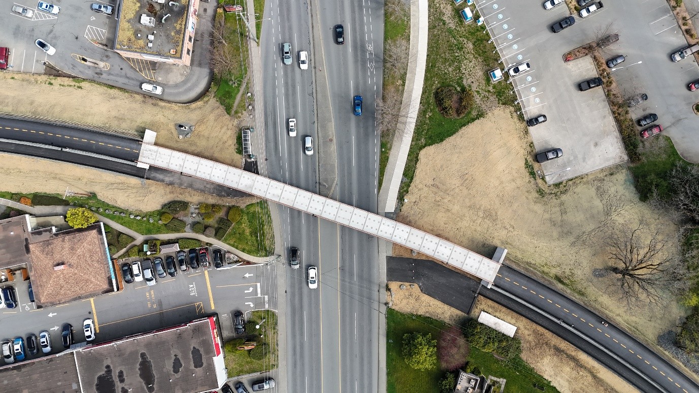 Overhead aerial view of the Galloping Goose pedestrian and cycling bridge crossing IslandHighway in Colwood, BC.